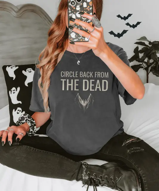Person wearing a Pepper tee printed with CIRCLE BACK FROM THE DEAD
