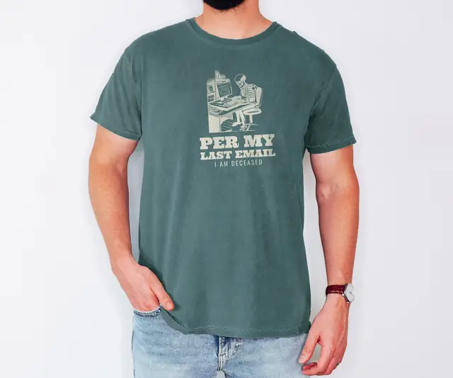 Person wearing a Blue Spruce tee printed with PER MY LAST EMAIL, I AM DECEASED