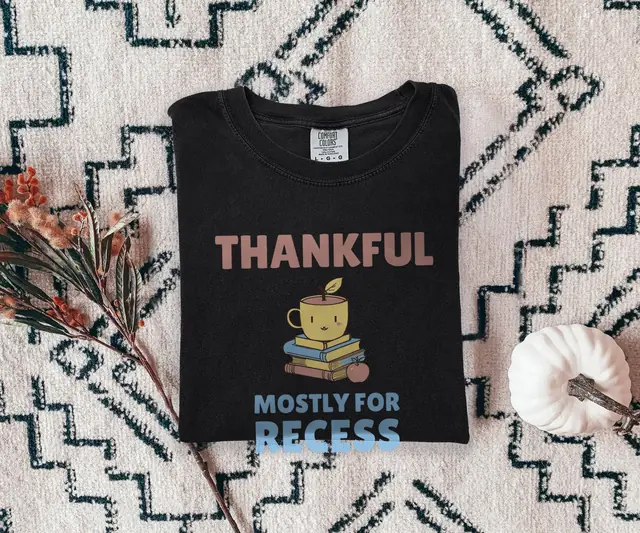 Person wearing a Black tee printed with THANKFUL, MOSTLY FOR RECESS