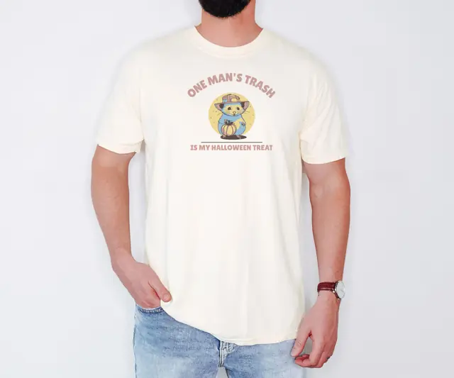 Person wearing a Ivory tee printed with ONE MAN'S TRASH, IS MY, HALLOWEEN TREAT