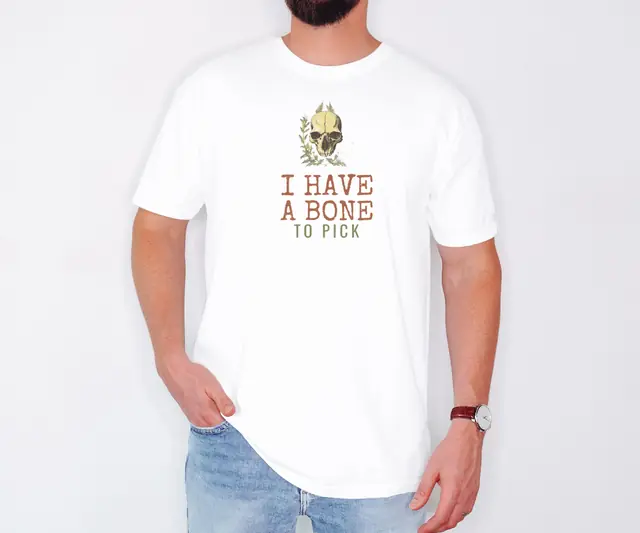 Person wearing a White tee printed with I HAVE A BONE, TO PICK