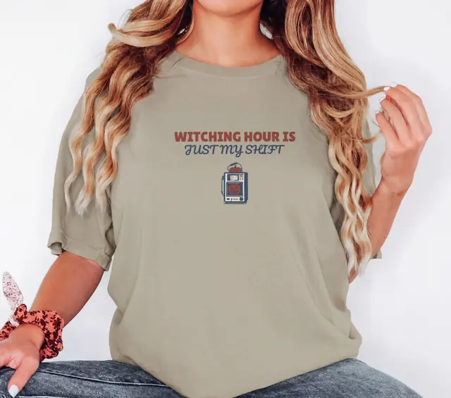 Person wearing a Khaki tee printed with WITCHING HOUR IS, JUST MY SHIFT