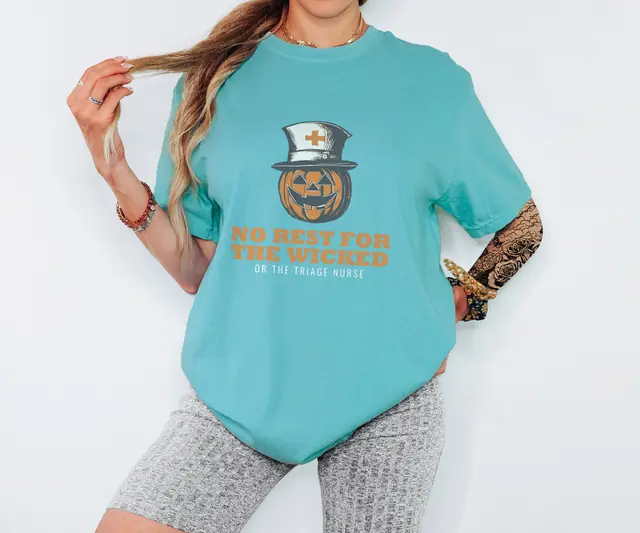 Person wearing a Seafoam tee printed with NO REST FOR THE WICKED, OR THE TRIAGE NURSE