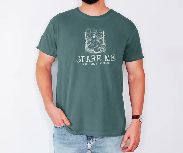 Person wearing a Blue Spruce tee printed with SPARE ME, YOUR GHOST STORIES