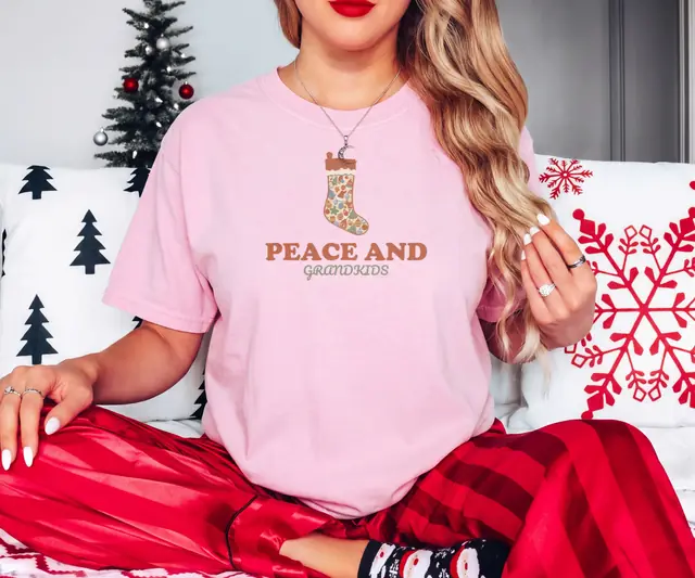 Person wearing a Blossom tee printed with PEACE AND, GRANDKIDS