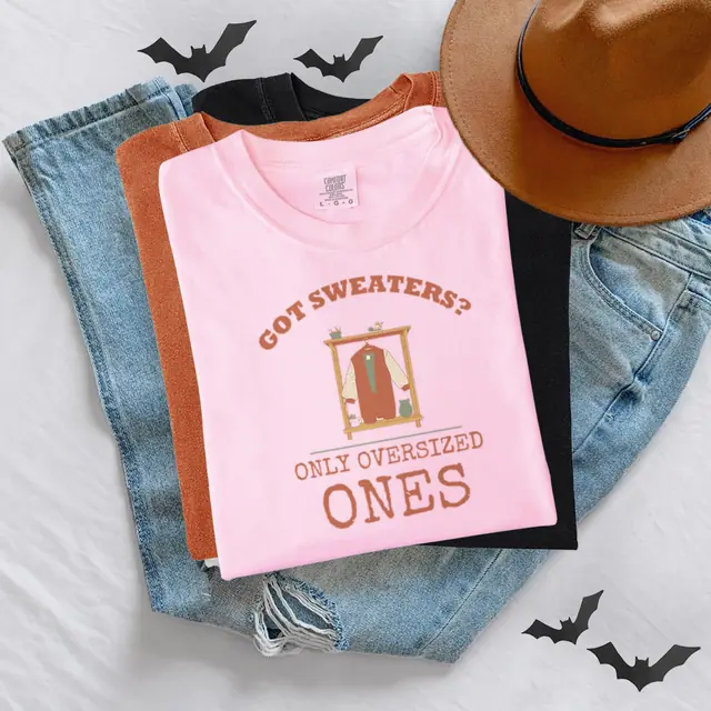 Person wearing a Blossom tee printed with GOT SWEATERS?, ONLY OVERSIZED ONES