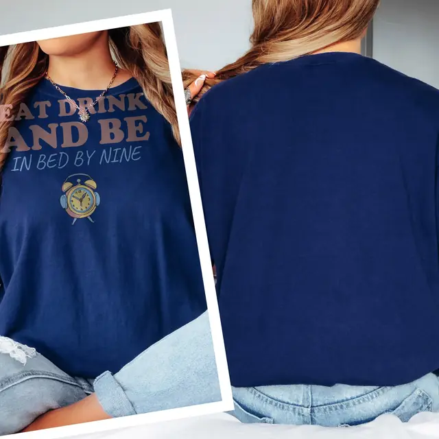 Person wearing a True Navy tee printed with EAT DRINK AND BE, IN BED BY NINE